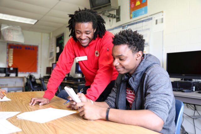 City Year AmeriCorps member tutors student